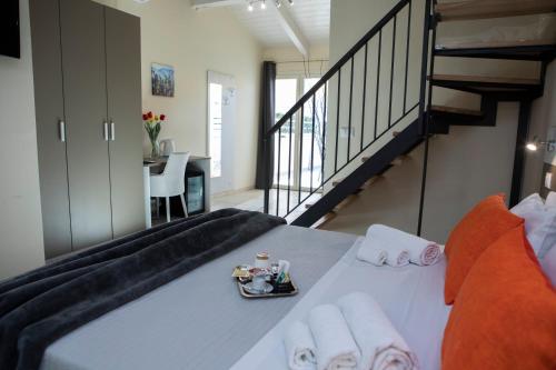 a bedroom with a large bed with a staircase at La Perla Amantea - Rooms & Apartaments in Amantea