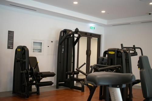 a gym with several tread machines in a room at Spectacular 2BR Apartment Full BurjAlArab View in Dubai