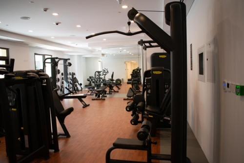 a gym with a bunch of tread machines in a room at Spectacular 2BR Apartment Full BurjAlArab View in Dubai
