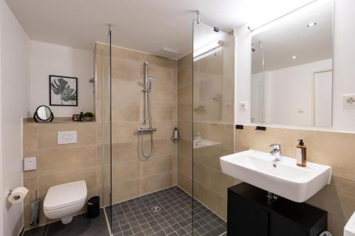 a bathroom with a sink and a shower at Svyvo Cologne - Serviced Suites in Cologne