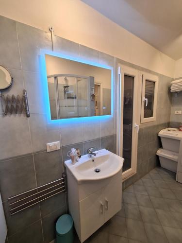 a bathroom with a sink and a mirror on the wall at Casa Garofoli in Frascati