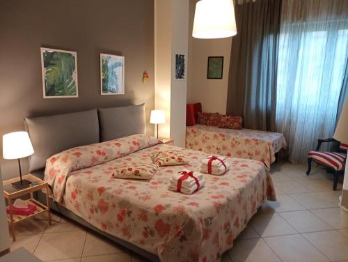 a hotel room with two beds with bows on them at Kaktus B&B in Bari