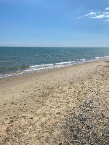 a sandy beach with the ocean in the background at Ballymoney, Wexford - 3 bed beach house with private beach access in Ballymoney Cross Roads