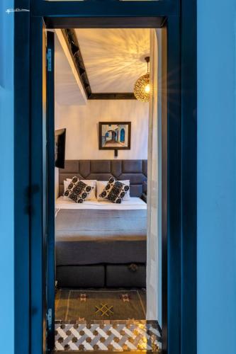 a bedroom with a bed in a room at Riad El Palacio & Spa Chaouen in Chefchaouene