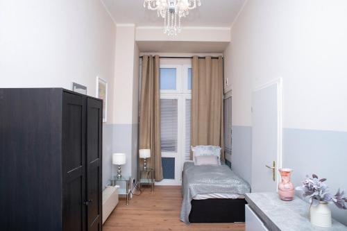 a small bedroom with a bed and a window at BIG CENTRAL CITY APARTMENT in Berlin