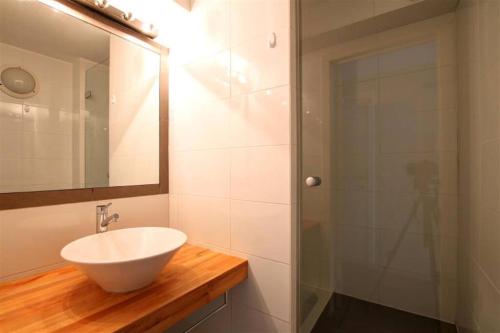 a bathroom with a sink and a glass shower at Studio near Place stéphanie in Brussels