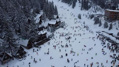 a group of people walking down a snow covered slope at Perfect Holidays in Vlasic