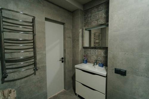 a bathroom with a sink and a shower at Eco Penthouse&rooftop terrace. in Chişinău