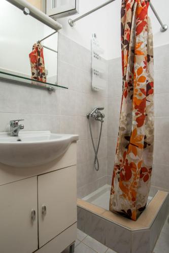 a bathroom with a sink and a shower at Dimitris studios & apartments in Faliraki