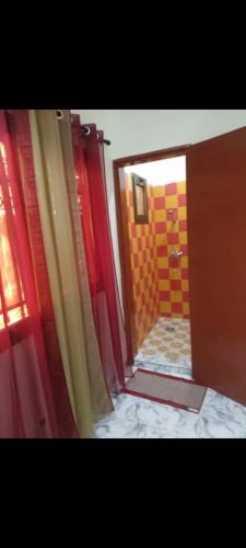 a view of a bathroom with a red shower curtain at Sawadogo meublée in Ouagadougou