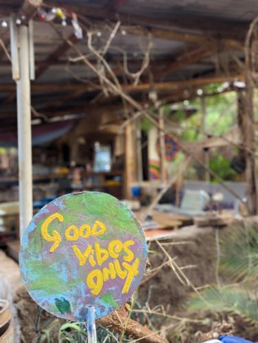 a sign that says good vibes only on it at Backyard Hostel in Moshi