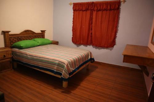 Tempat tidur dalam kamar di EL CAPIRO