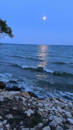 a body of water with rocks and the ocean at Alex Beach in Elenite