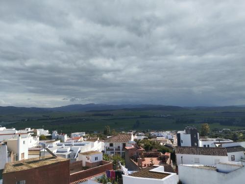 a view of a city with buildings and mountains at El Celemín in Benalup Casas Viejas