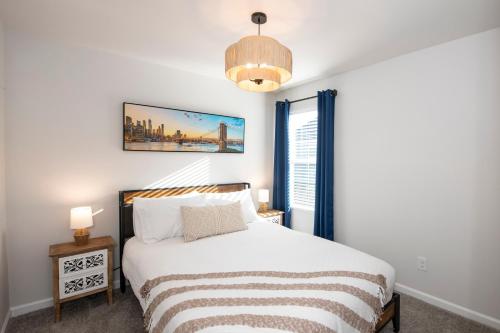 a bedroom with a bed and a window at Cozy Coastal Home Near Beaches, Shops, Restaurants in Southport