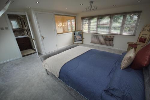 a bedroom with a large bed with a blue blanket at The Woodstock in Birmingham