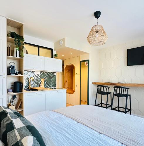 1 dormitorio con 1 cama y cocina en L’émeraude - Superbe studio tout équipé + parking en Metz