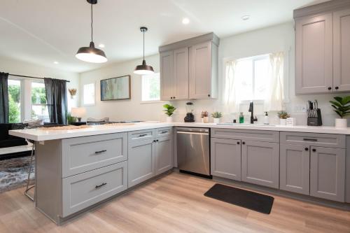 a kitchen with white cabinets and white counter tops at Epic House in Atwater Village in Glendale