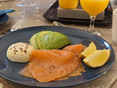 a blue plate with fish and vegetables on a table at Sidney Grove B&B in Newcastle upon Tyne