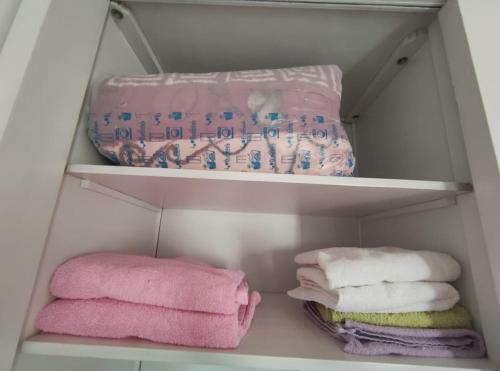 a white closet with pink towels in it at Madinty amazing view 2 rooms fully air-conditioned apartment at Madinty city for families only مدينتي in Madinaty