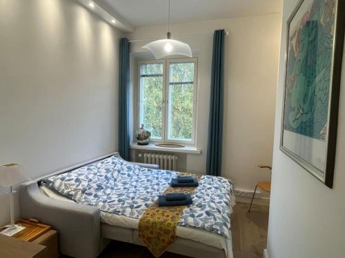 a bedroom with a bed and a window at Cozy apartment next to Finnish culture spots in Helsinki