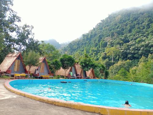 a large swimming pool in front of a mountain at NongKhiaw CampingSite Swimming Pool in Ban Nongkham