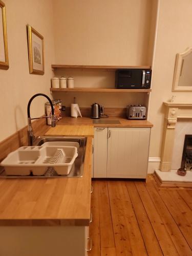 a kitchen with a sink and a counter top at 3 Bedroom villa attached to Host home free parking in Perth