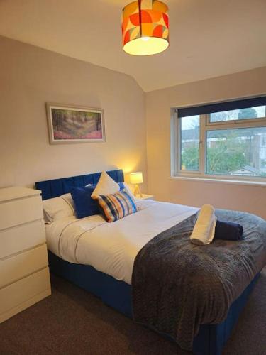 een slaapkamer met een groot bed en een raam bij SwankyHome4Groups/Contractors/M6 in Birmingham