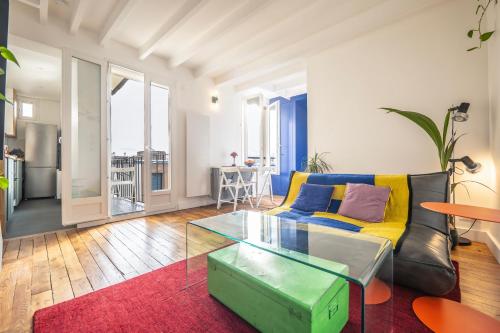 un salon avec un canapé et une table dans l'établissement Appartement cosy pour deux aux portes de Paris, à Montreuil