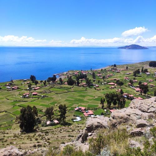 a small town on the shore of a large body of water at Dawn House - Lago Titicaca in Amantani