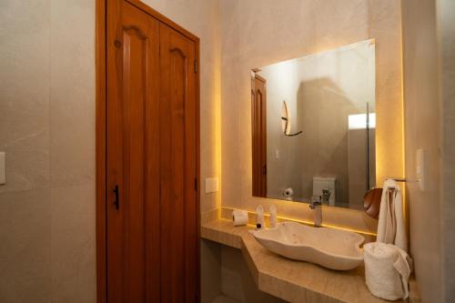 a bathroom with a sink and a large mirror at Casalinda San Miguel in San Miguel de Allende