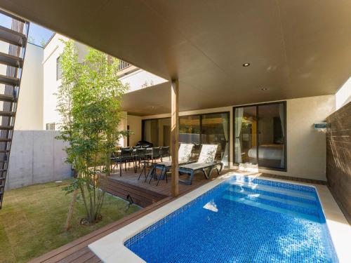 a swimming pool in the backyard of a house at Rakuten STAY VILLA Kamogawa in Kamogawa