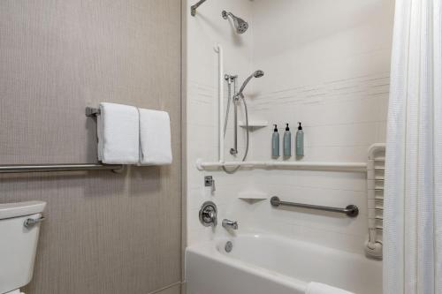 a bathroom with a shower and a tub and a toilet at Residence Inn by Marriott Tempe Downtown/University in Tempe
