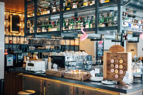 a kitchen with a counter top with a coffee shop at Moxy Osaka Umeda in Osaka
