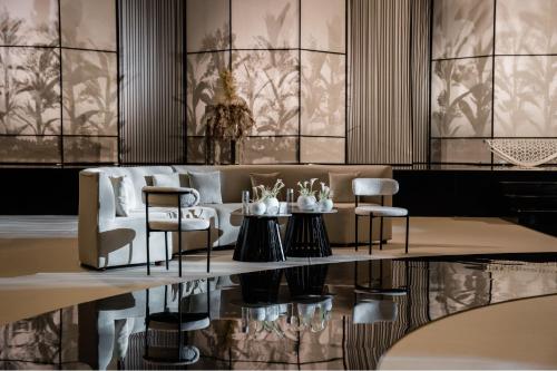 a lobby with a couch and chairs and a table at The St. Regis Abu Dhabi in Abu Dhabi