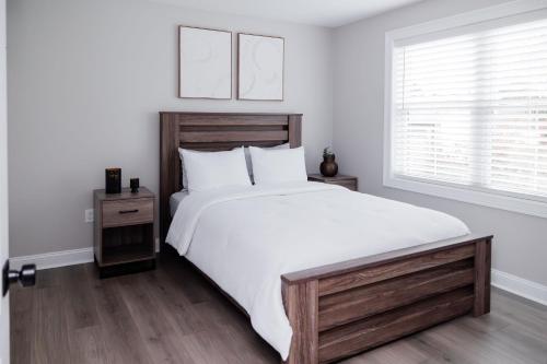 a bedroom with a large white bed and a window at Rest in Westerly in Westerly