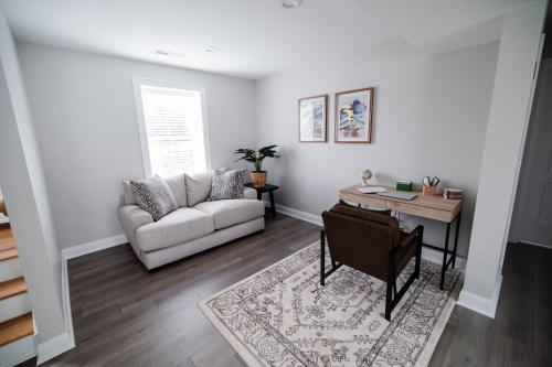 a living room with a couch and a table at Rest in Westerly in Westerly