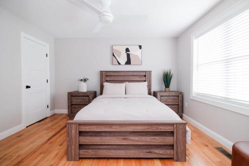 a bedroom with a large bed and two windows at Rest in Westerly in Westerly