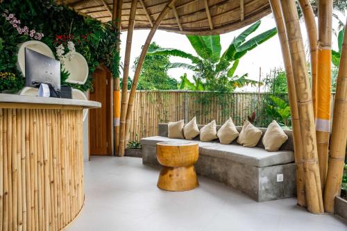 a patio with a couch and a table at Shanti Boutique Retreat in Tanah Lot