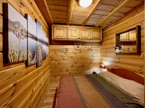 een slaapkamer in een blokhut met een bed erin bij Chalet Pierra, pied des pistes - Wifi gratuit - 2 parkings in Le Dévoluy