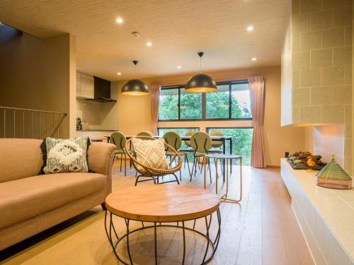 a living room with a couch and a table at Rakuten STAY VILLA Kamogawa in Kamogawa