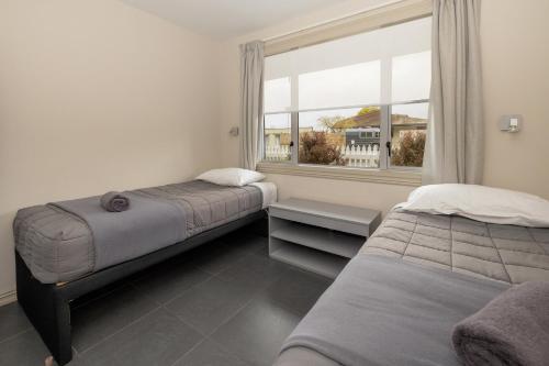 a bedroom with two beds and a window at Ohakune TOP 10 Holiday Park in Ohakune