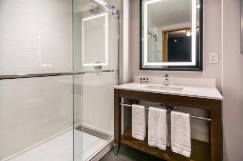 a bathroom with a sink and a shower at Four Points by Sheraton Deadwood in Deadwood