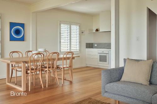 a kitchen and dining room with a table and chairs at Bluewater on the Beach in Byron Bay