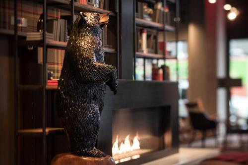 a statue of a bear standing in front of a fireplace at MOXY Seattle Downtown in Seattle