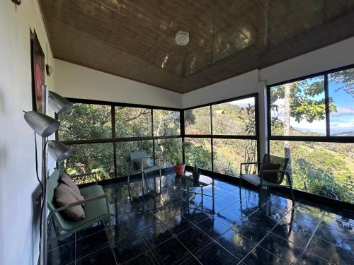 a living room with glass floors and large windows at Carbell House in La Cruz