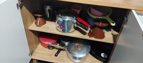 a wooden cupboard with a bunch of items in it at Casa Temporada em Embu das Artes in Embu