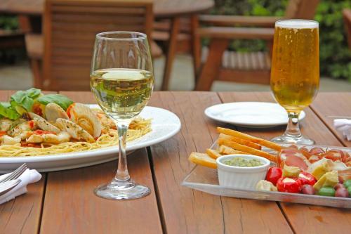 a table with a plate of food and two glasses of wine at Edit Hanmer Springs in Hanmer Springs