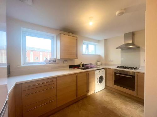 a kitchen with a sink and a dishwasher at Spacious room with study table in Hatfield