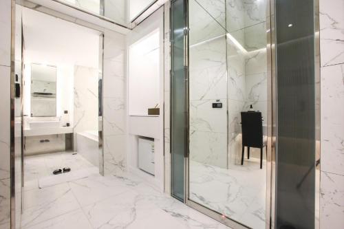 a bathroom with a shower and a glass door at Hotel Star Premier Yeoksam in Seoul